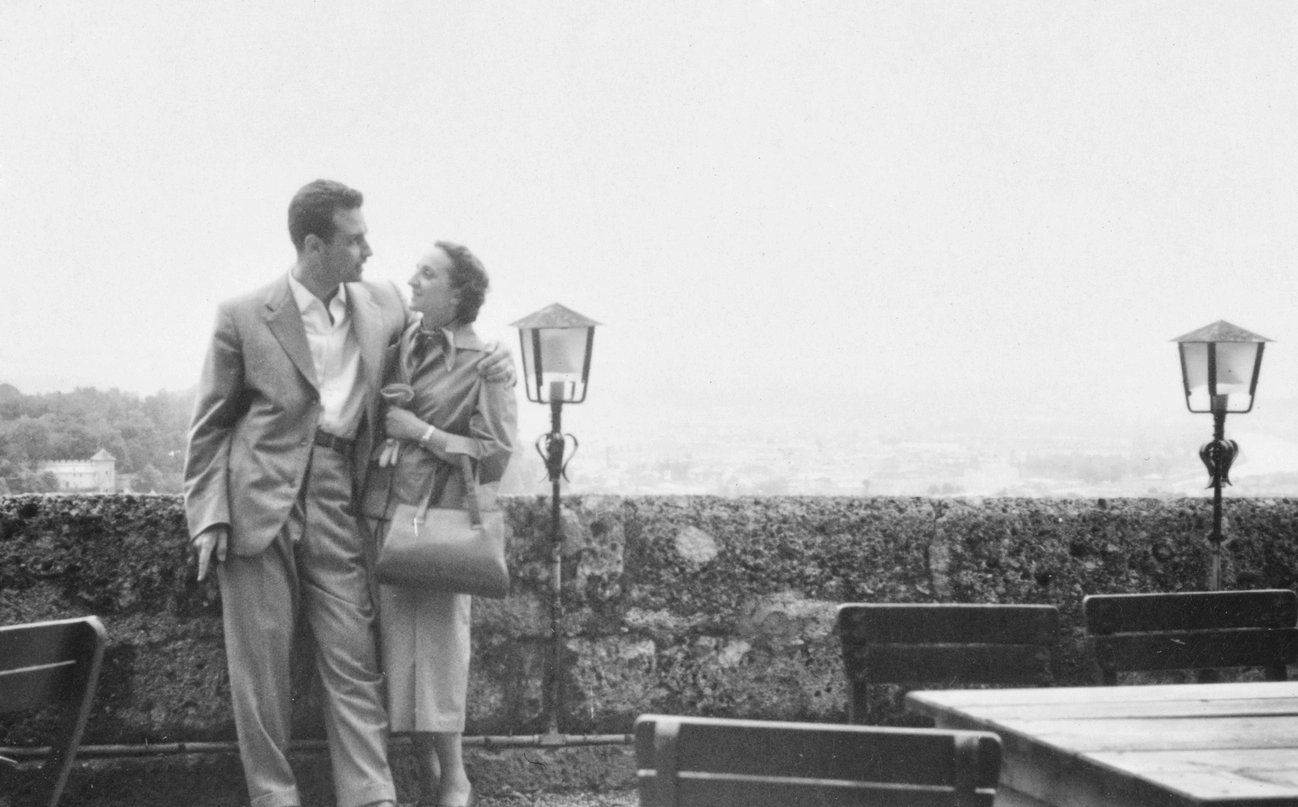 Image of Dateable couple embracing at a cafe.