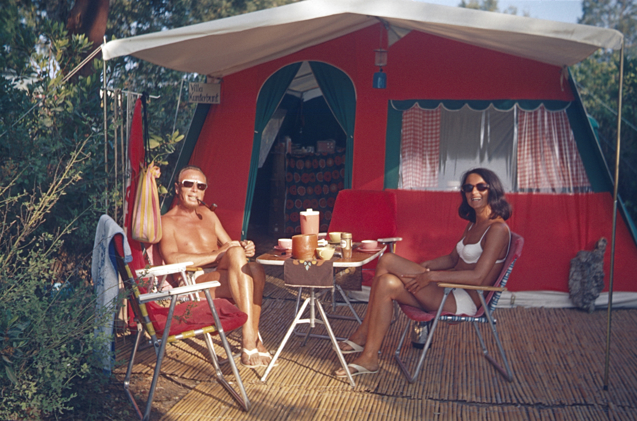 Image of happy Dateable couple eating lunch while camping.