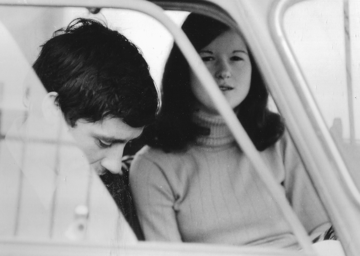 Black and white image of young Dateable couple in a car.